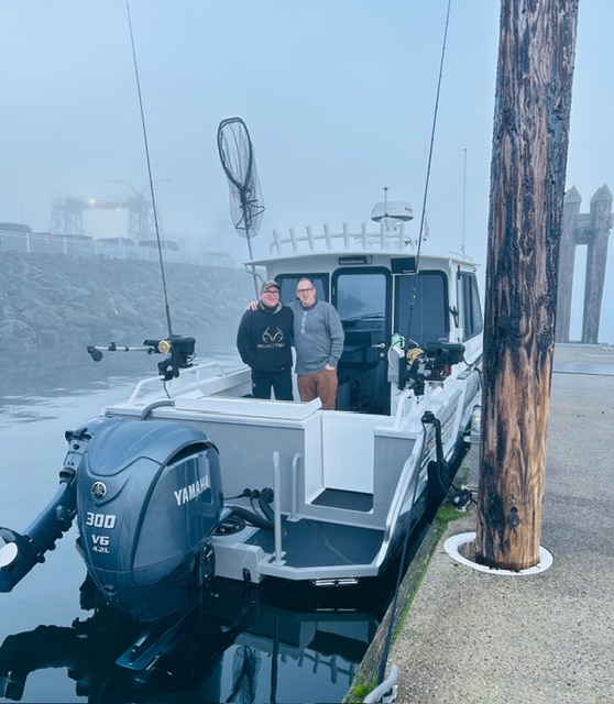 Kwigwis Adventures fishing charter boat docked at a pier in Campbell River, BC, showcasing the vessel ready for coastal adventures.